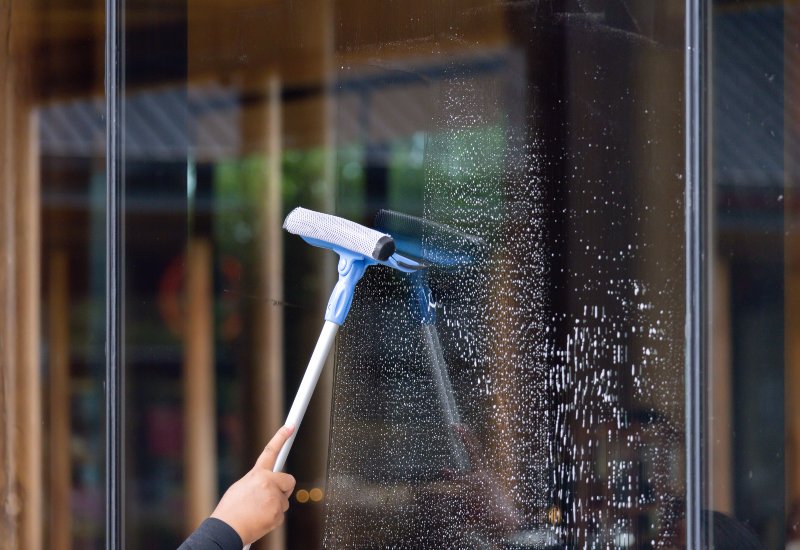 A window is getting cleaned by an expert from A Clear View Window Cleaning in Stewartstown, PA